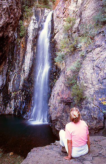 A hiker enjoys the view at Cattail Falls