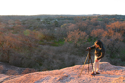Photographer shoots the sunrise at Enchanted Rock State natural area. Image #5