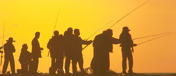 Fisherman line up on the Quintana jetties in Freeport.